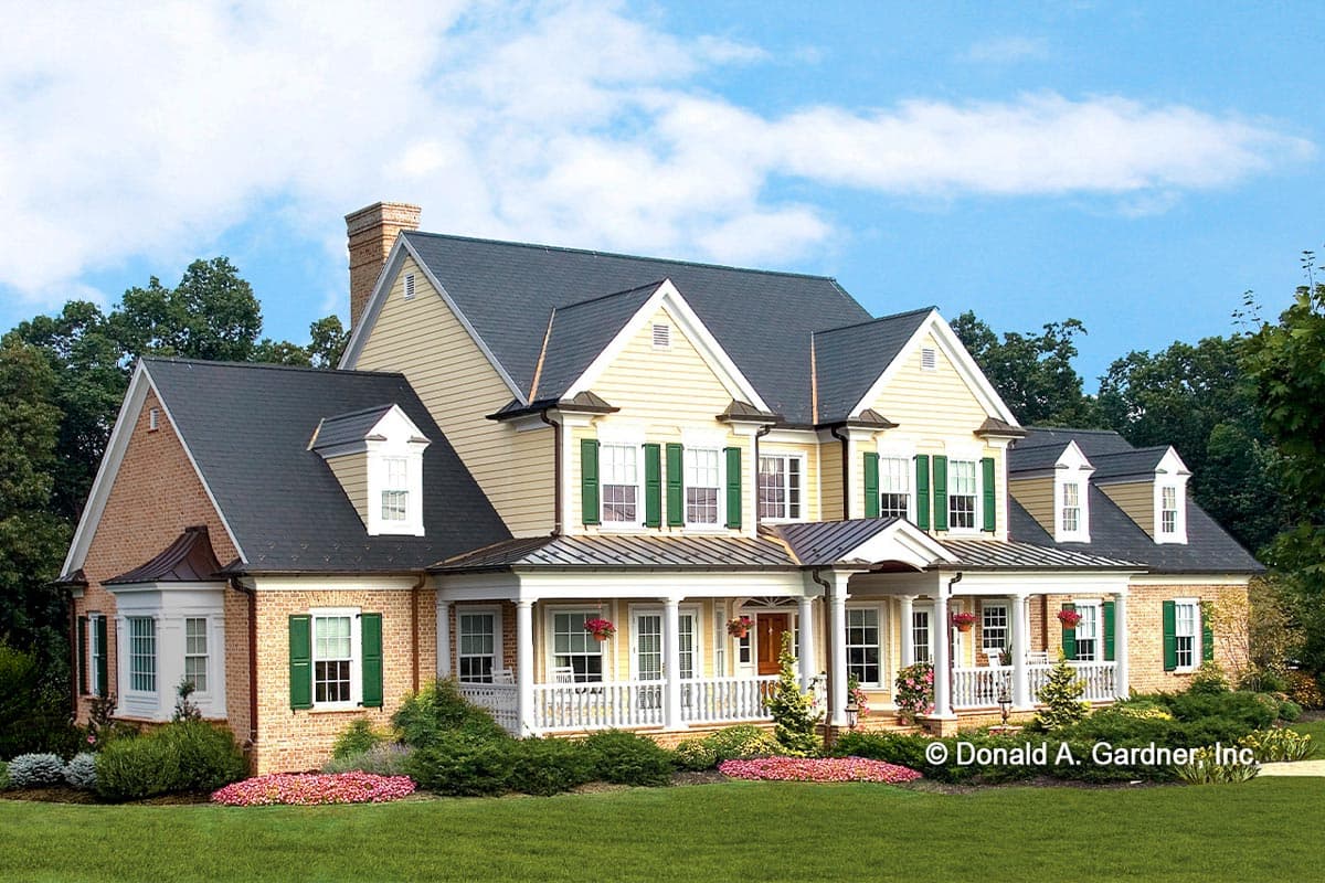 House plan exterior featuring a two-story Colonial style home with a front porch, gables, and multiple dormers on the roof.