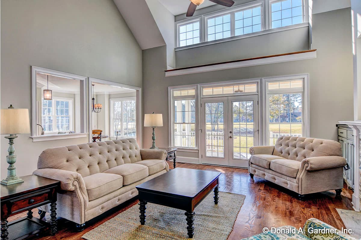 Great room with vaulted ceiling, fireplace, and French doors leading to the outdoors.