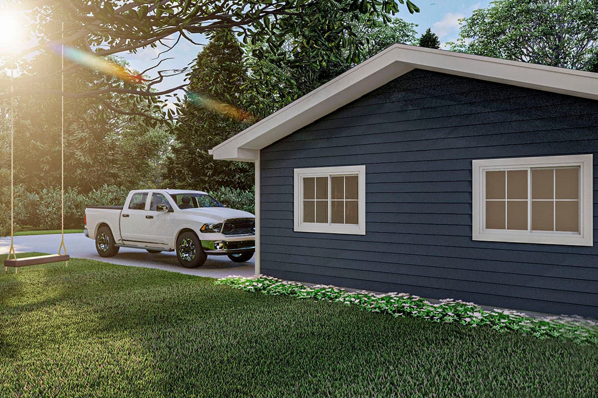 House plan exterior with lap siding, gable roof, and two double-hung windows. White pickup truck parked nearby.