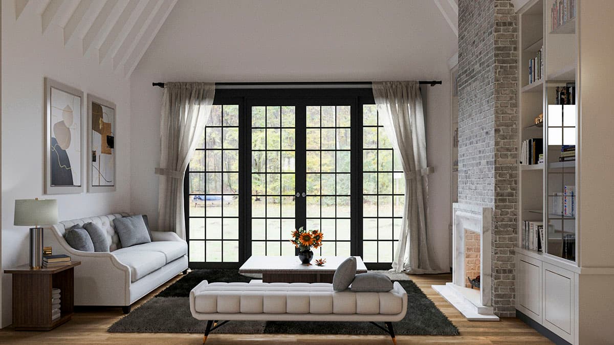 Living room with vaulted ceiling, fireplace, built-in bookshelves, and large French doors.