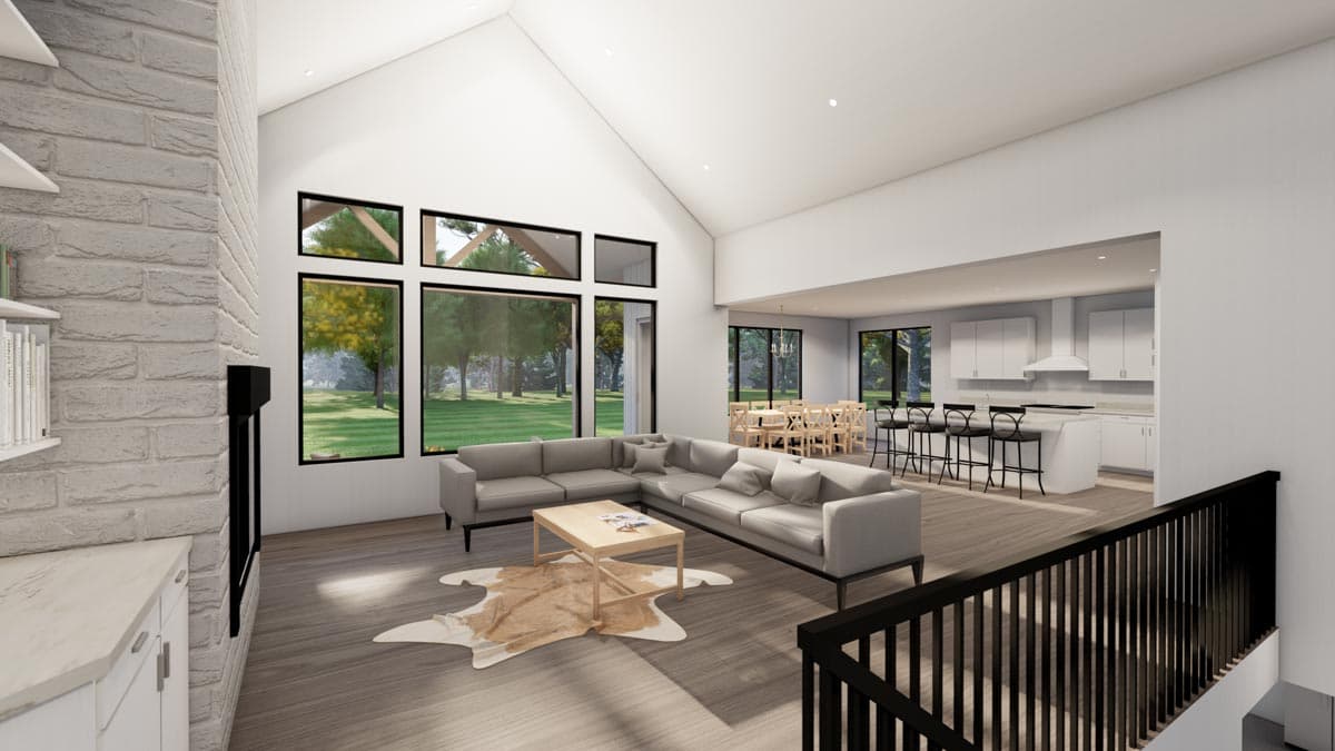 Great room with vaulted ceiling, fireplace, sectional sofa, and open-concept kitchen with island.
