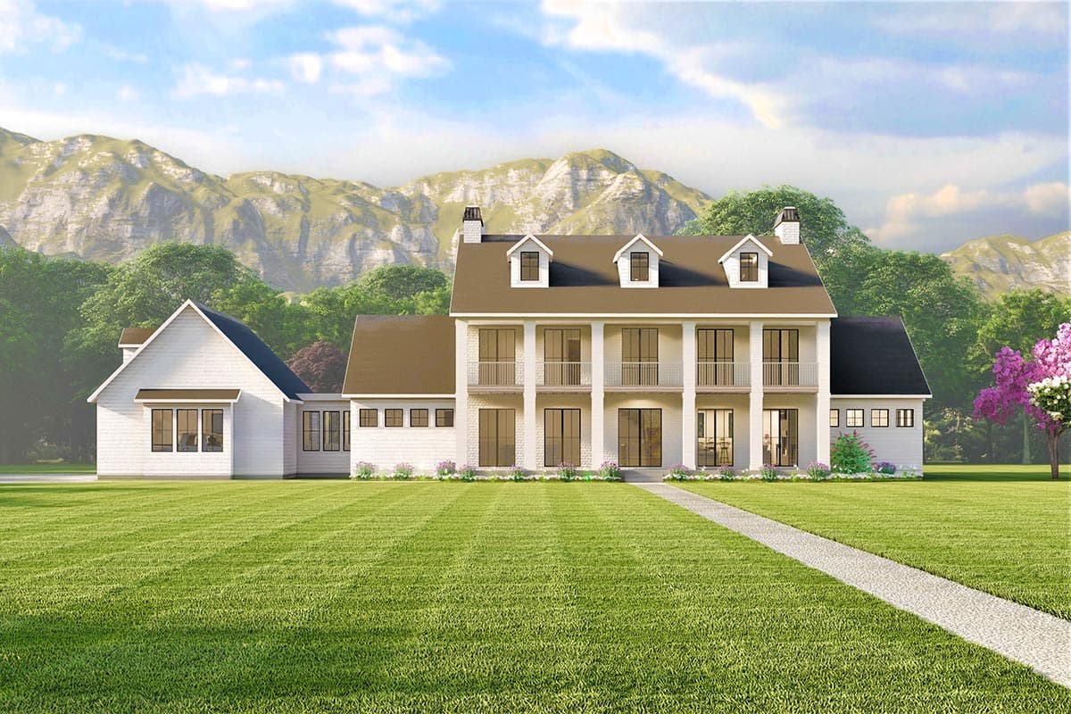 House plan exterior rendering. Two-story Colonial with dormers, balconies, and a gabled roof over a side wing. Features an expansive lawn and walkway.