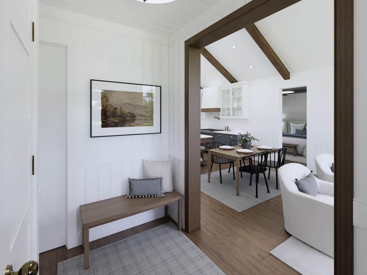 A hallway with a bench, leading to a dining area and kitchen. A landscape painting hangs above the bench. Adjacent rooms are visible.