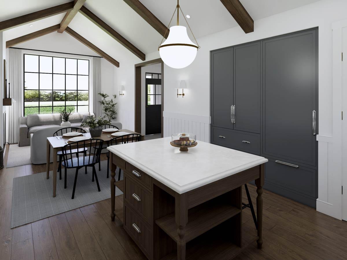 Spacious, modern kitchen with an island, dining table, and large window overlooking a yard; hardwood floors and dark cabinetry.