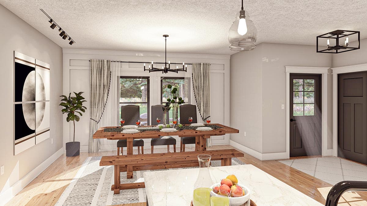 Dining area with wooden table and bench, paneled wall, track lighting, and doors leading outdoors.