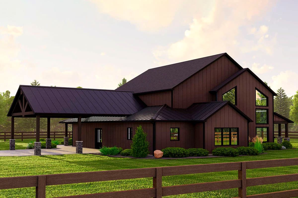 House plan exterior: Modern Barn style, two stories, features a covered carport with stone pillars, dark metal roof, and asymmetrical gables.