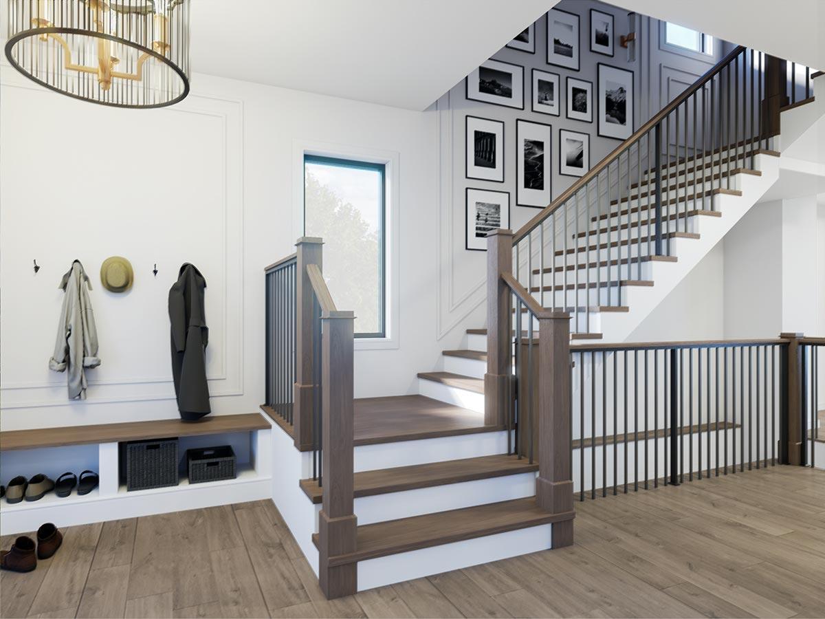 Modern entryway with wood bench, coat hooks, and staircase featuring wood treads and metal railings. Gallery wall above.