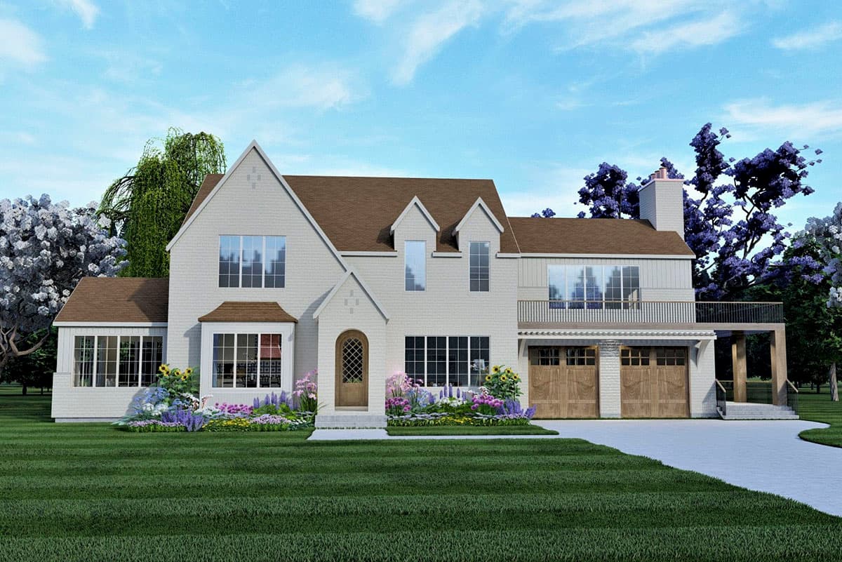 House plan exterior: Two-story house in a Tudor style with gabled roof, dormers, a balcony, and a two-car garage.