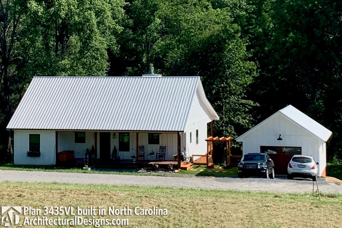 House plan exterior: Modern Farmhouse style, one story, with a deep covered front porch and metal roof.