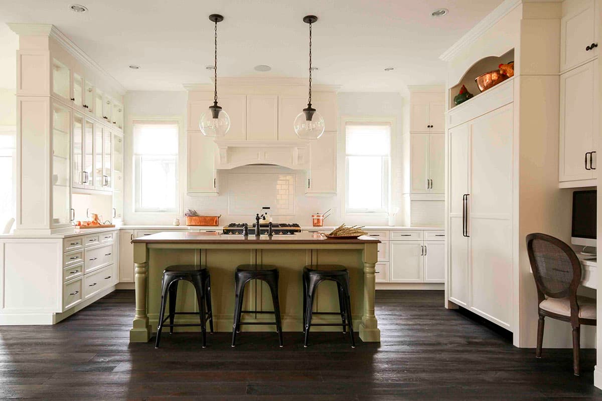 Kitchen with center island, range, ample cabinetry, glass-front cabinets, and a built-in refrigerator.