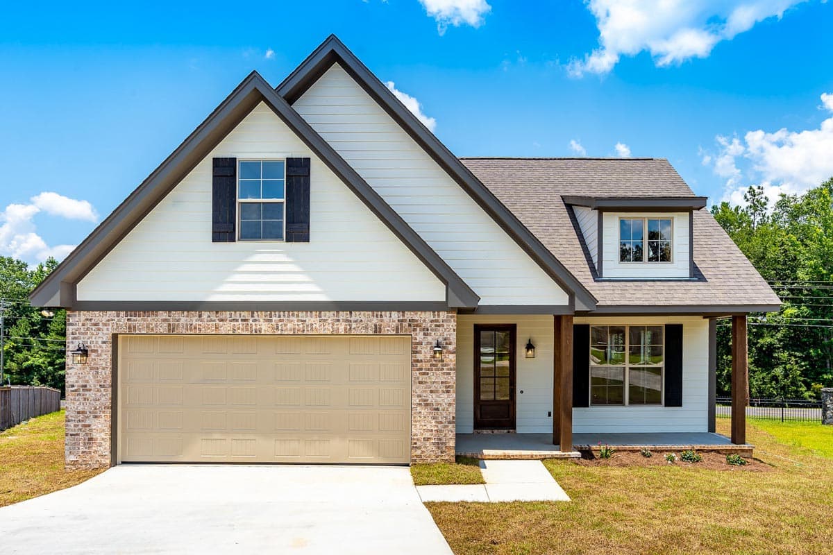 House plan exterior. Two-story Modern Farmhouse with gabled roof, brick accents, garage, and front porch with columns.