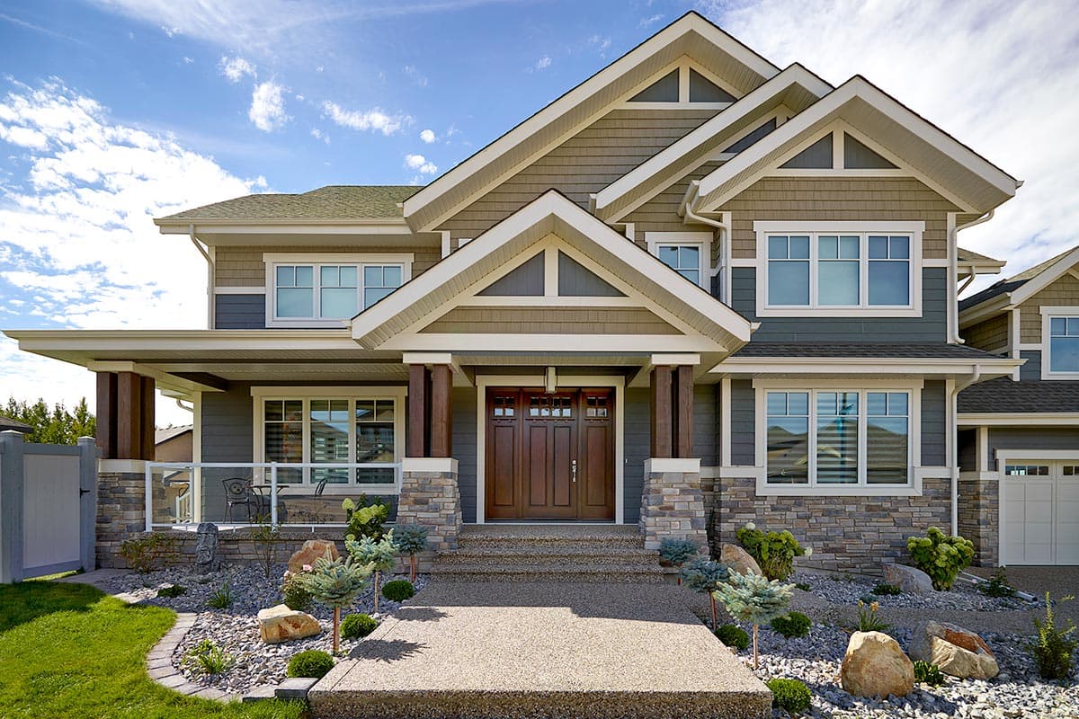 House plan exterior: Two-story Modern Farmhouse with stone and shingle siding, large covered porch, and multiple gables.