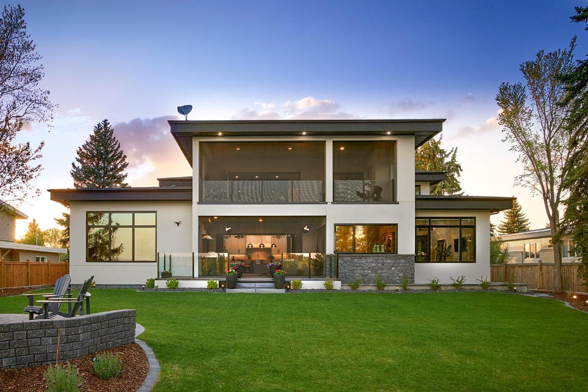 Modern two-story house plan exterior with large screened porches, stone accents, and extensive glazing.