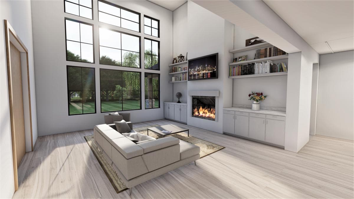 Great room with a fireplace, built-in shelving, and a wall of tall windows. Includes sectional sofa and coffee table.