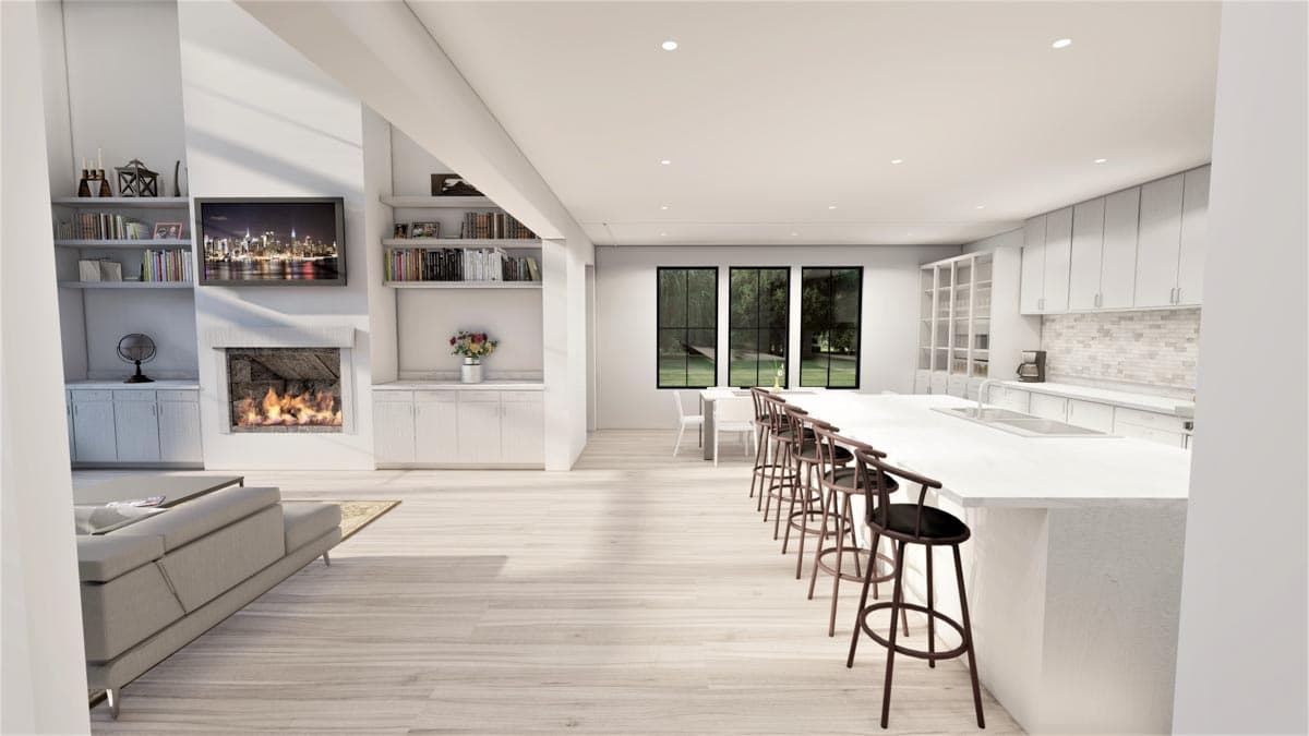 Open concept living area with fireplace, built-in shelving, kitchen island with bar stools, and dining area with three windows.