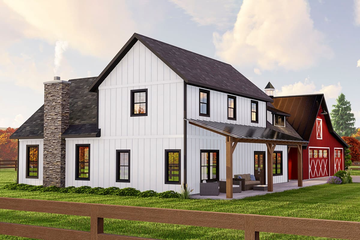 Modern Farmhouse exterior with white board and batten siding, stone chimney, covered porch, and attached red barn.