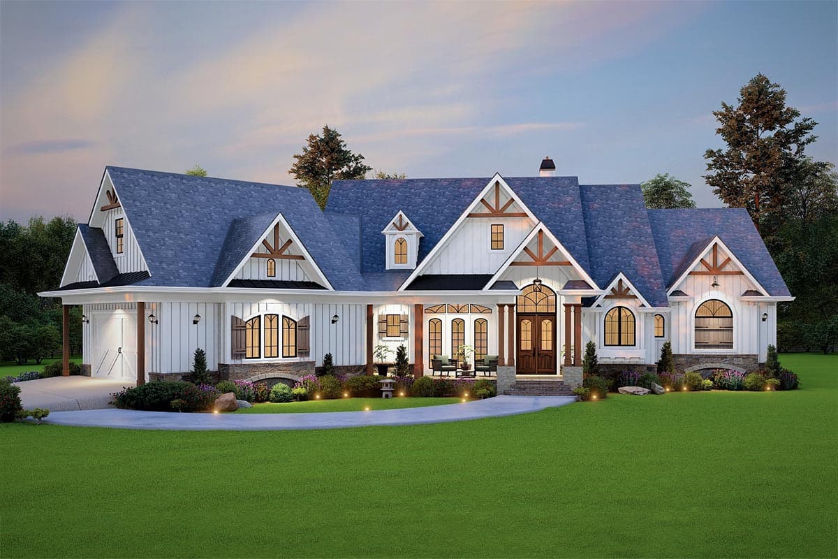 House plan exterior. Farmhouse style with multiple gables, arched windows, a covered porch, and a two-car garage. Features a blue shingle roof.