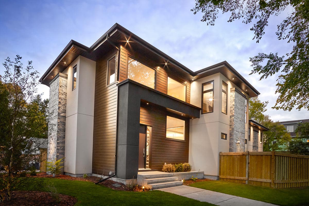 House plan exterior. Modern style, two-story home with a flat roof, stone accent wall, and wood siding. Features include a covered entry and large windows.