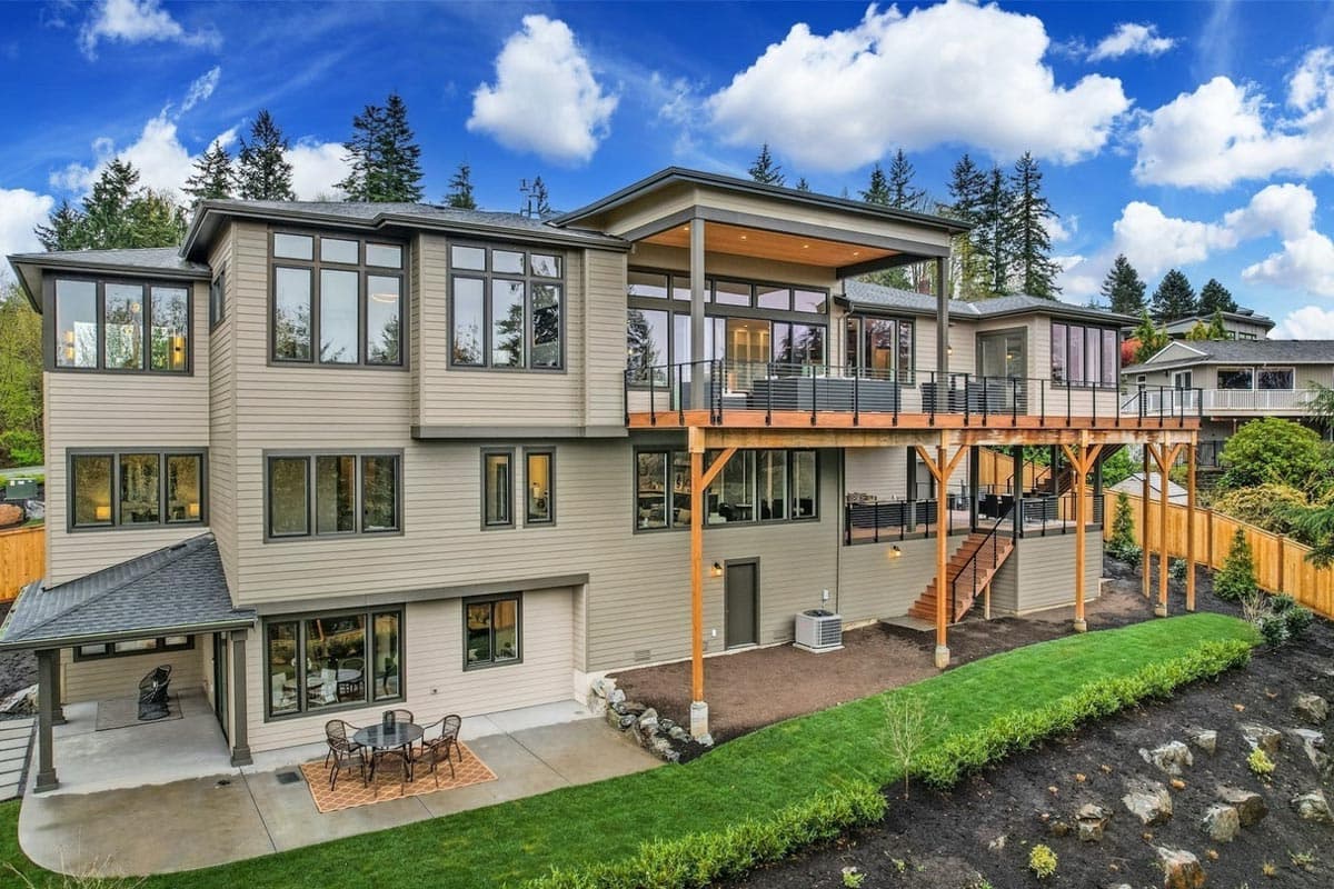 Contemporary house plan exterior, multi-level design with large windows, covered upper deck, and lower patio.