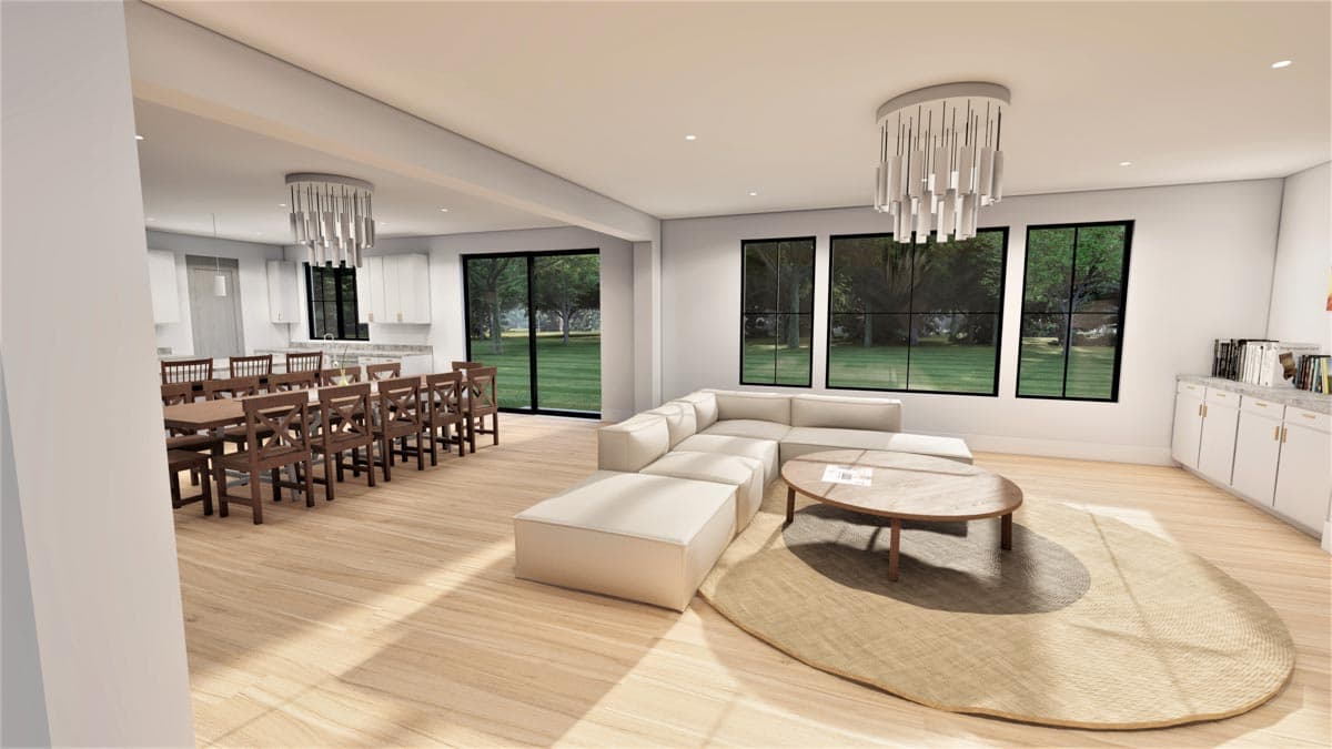Open concept living and dining area with a sectional sofa, coffee table, large windows, and a long dining table.