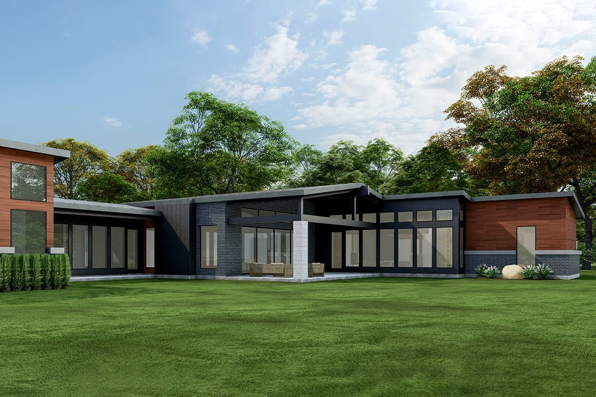 Modern ranch house plan exterior with multiple gables, large windows, and wood and brick accents.