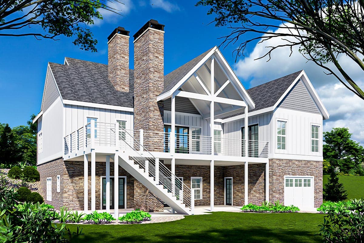 Modern Farmhouse house plan exterior with stone foundation, board and batten siding, prominent stone chimneys, and a covered balcony.