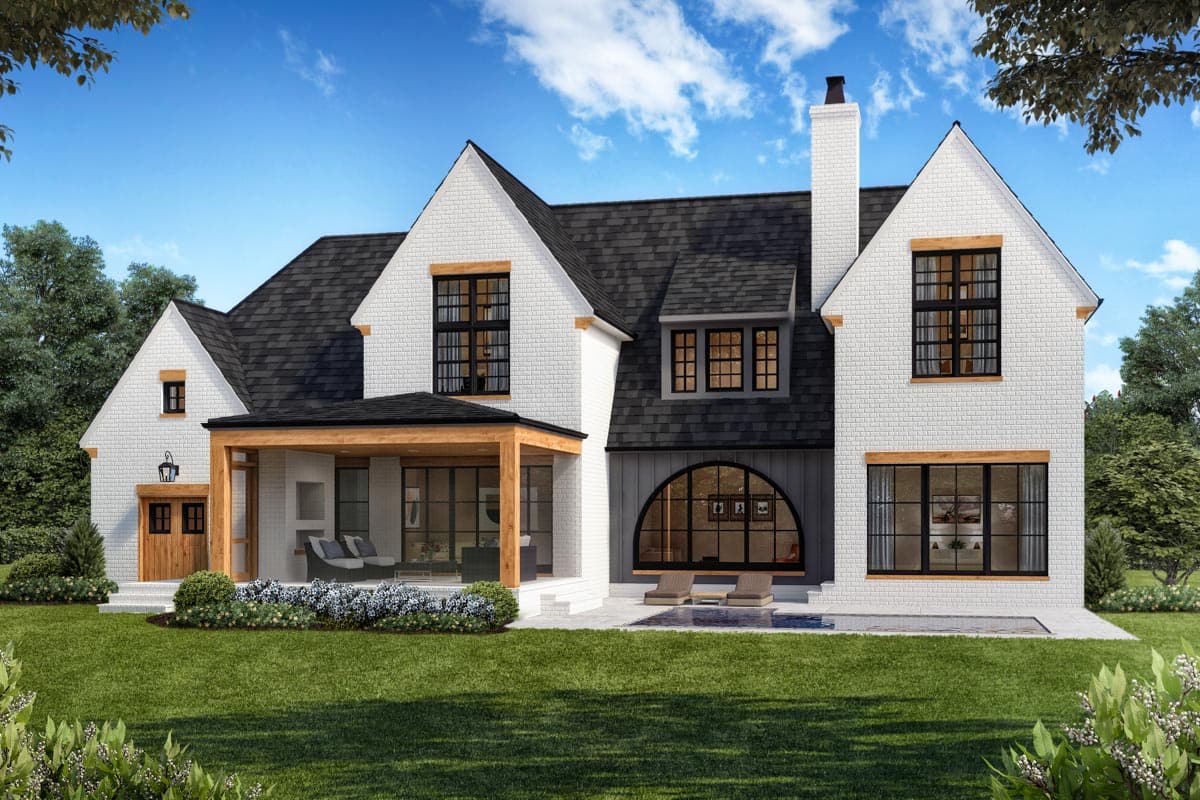 Modern Farmhouse house plan exterior with white brick, gables, a covered porch, and a large arched window.