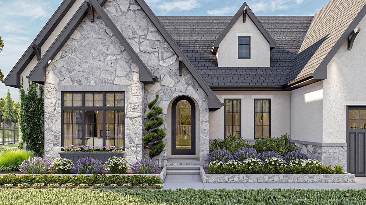 House plan exterior featuring stone facade, arched entryway, gables, dormer, and multiple windows.