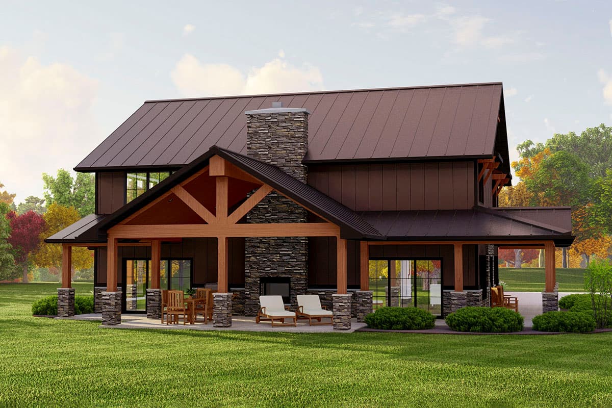 Modern Farmhouse style house plan exterior with a gabled roof, stone chimney, large covered porch with exposed beams, and stone-clad columns.