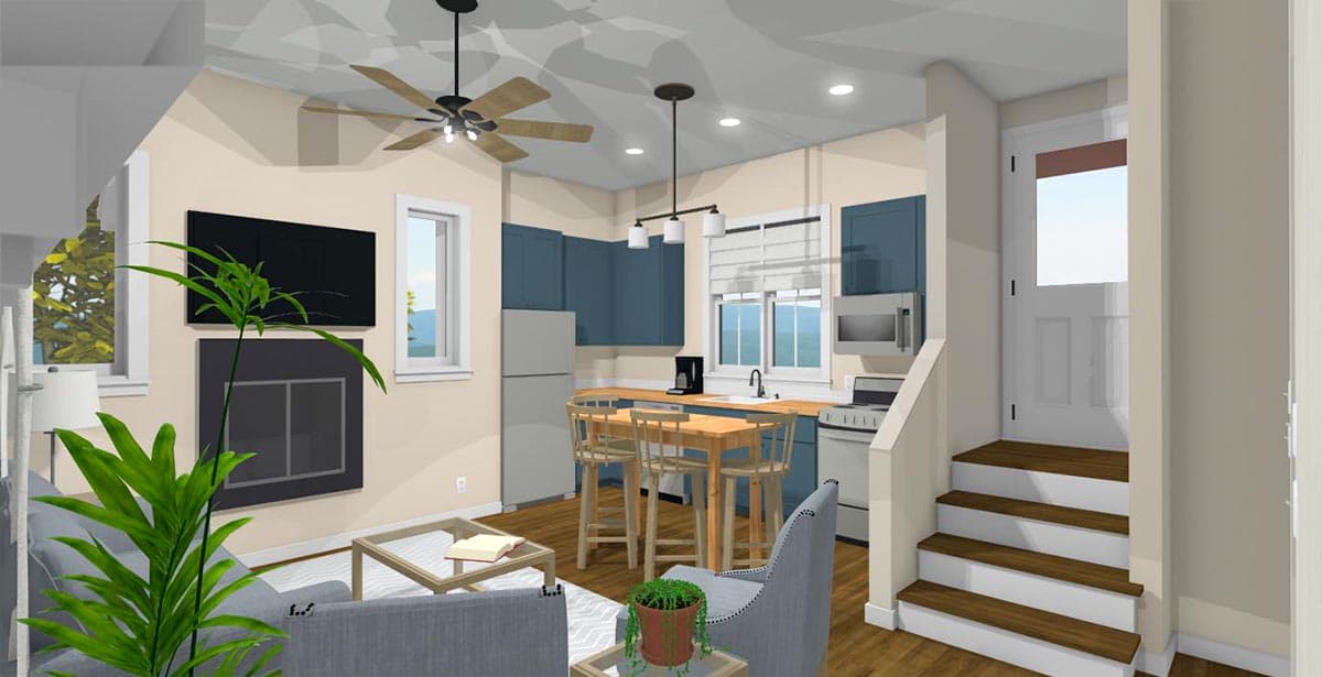 Interior view of a living area with fireplace, kitchen with island, and stairs leading to a door.