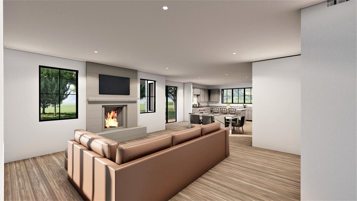 Interior rendering of a great room with fireplace, sofa, and view of open kitchen with island and dining area.
