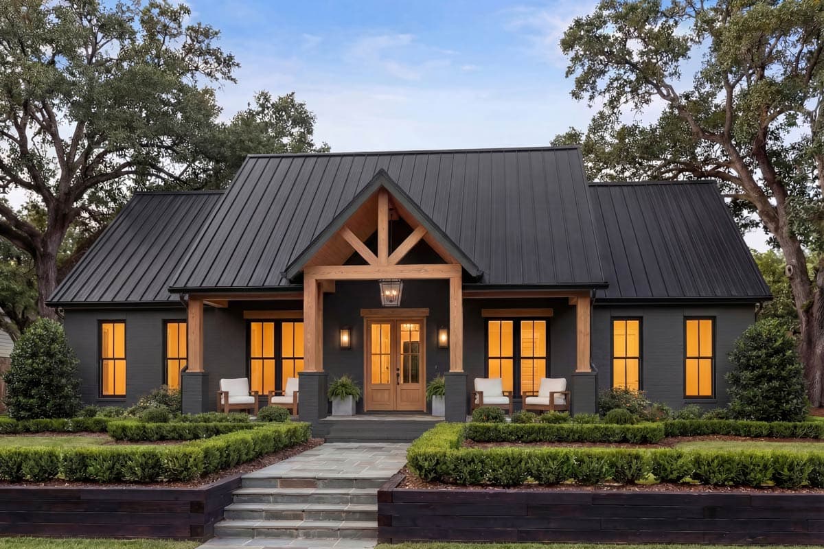 Modern Farmhouse house plan exterior with a dark metal roof, exposed wooden beams over the entryway, and a symmetrical facade.