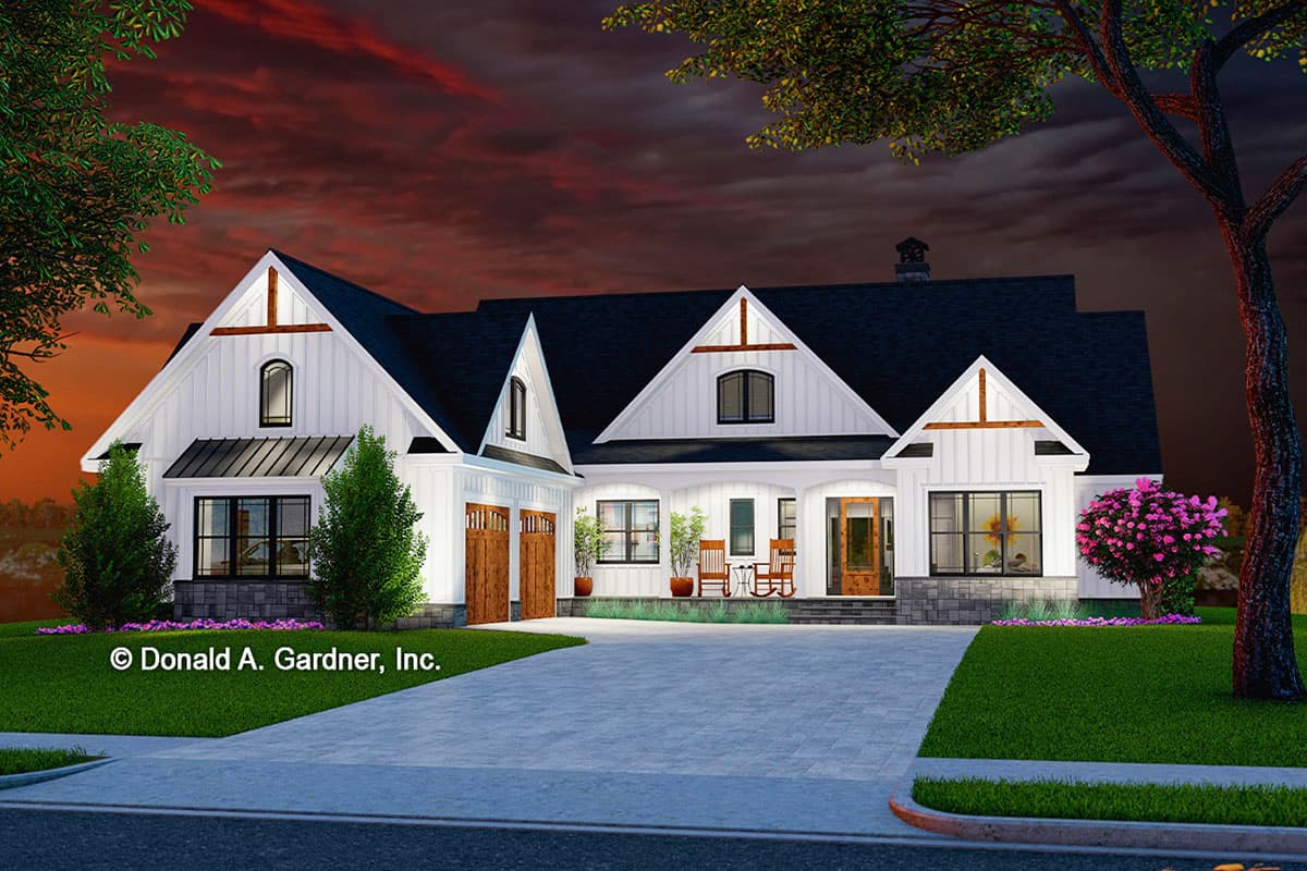 Modern Farmhouse style house plan exterior with two-car garage, prominent gables, arched window, and covered entry porch.