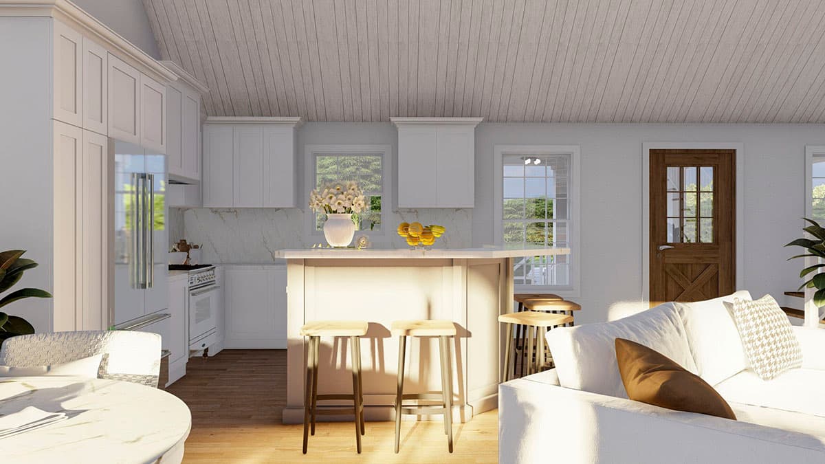 Kitchen and living area with vaulted ceiling, white cabinets, island with seating, and wood plank door.