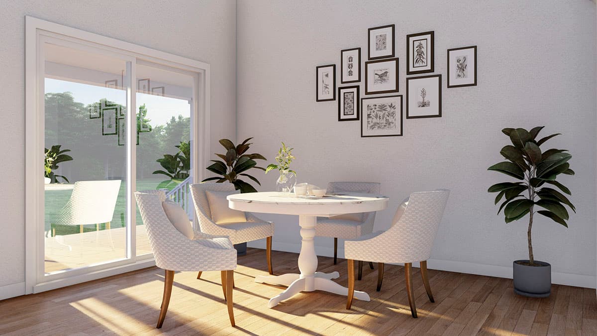 Dining area with round pedestal table, upholstered chairs, gallery wall, and sliding glass door to patio.