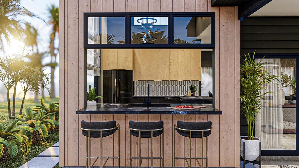 Kitchen pass-through with bar seating, wood siding, and dark cabinetry visible through three windows.