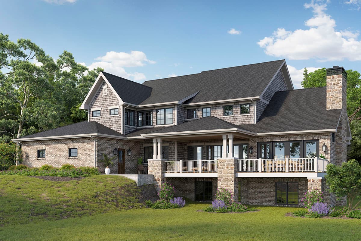 House plan exterior: multi-story home with brick and shake siding, large covered deck, and prominent stone chimney.