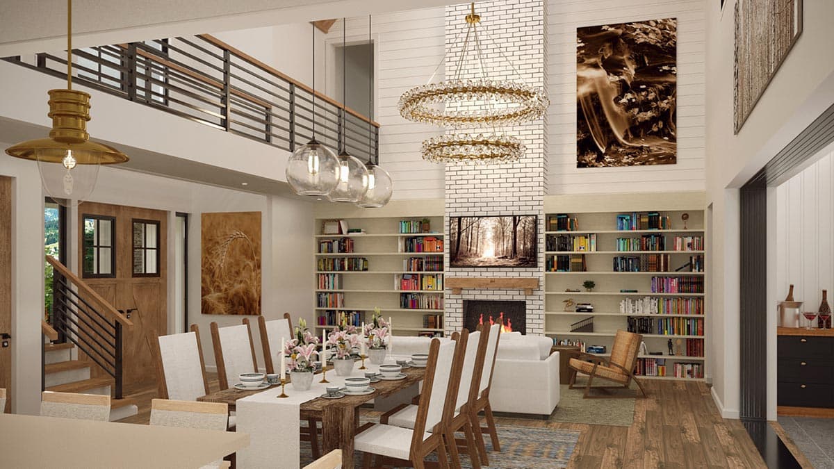 Open-concept living space with a vaulted ceiling, fireplace, built-in bookshelves, dining area, and loft overlooking the great room.