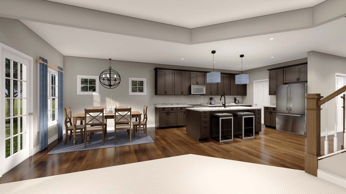 Open concept kitchen and dining area with dark wood cabinets, island, stainless steel appliances, and dining table.