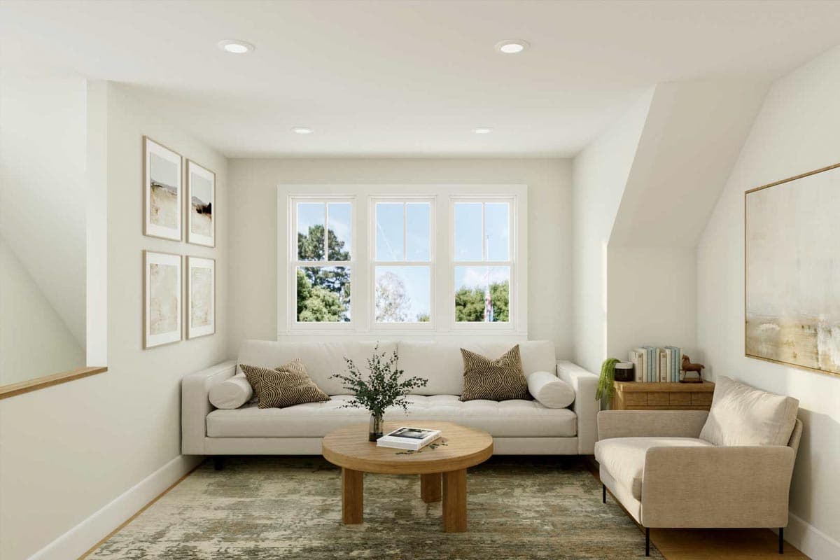 Interior rendering of a living area with a sofa, accent chair, coffee table, and three windows.