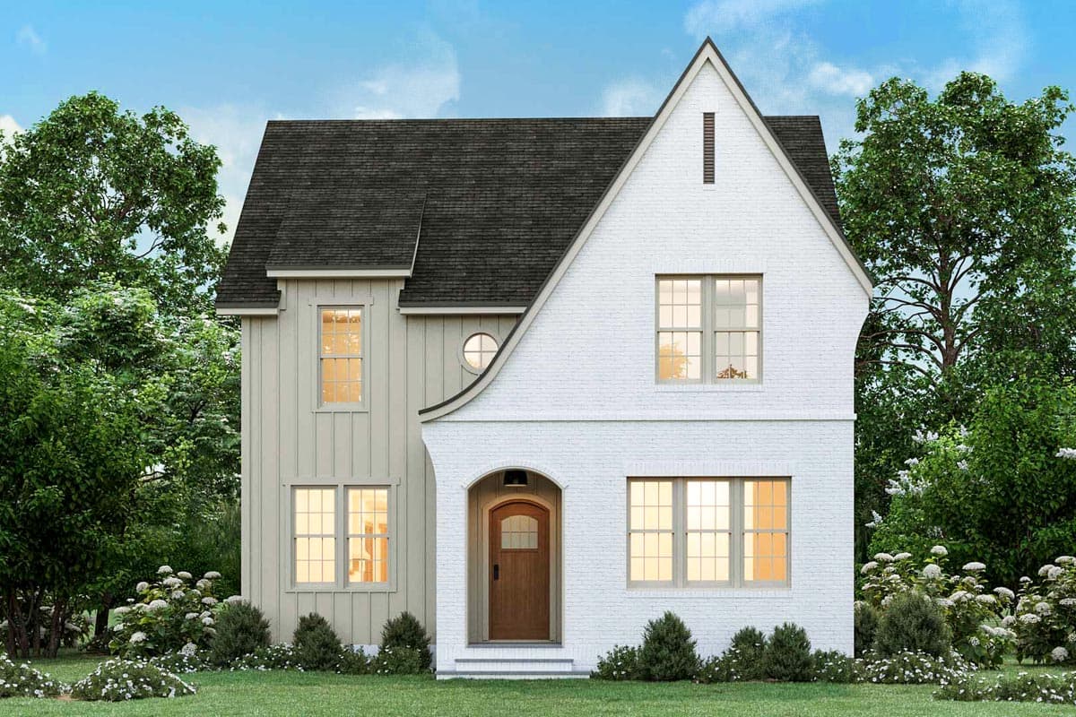 A two-story white brick home with a contrasting dark roof, wooden door, and a well-manicured lawn. Green trees and shrubbery surround the house.