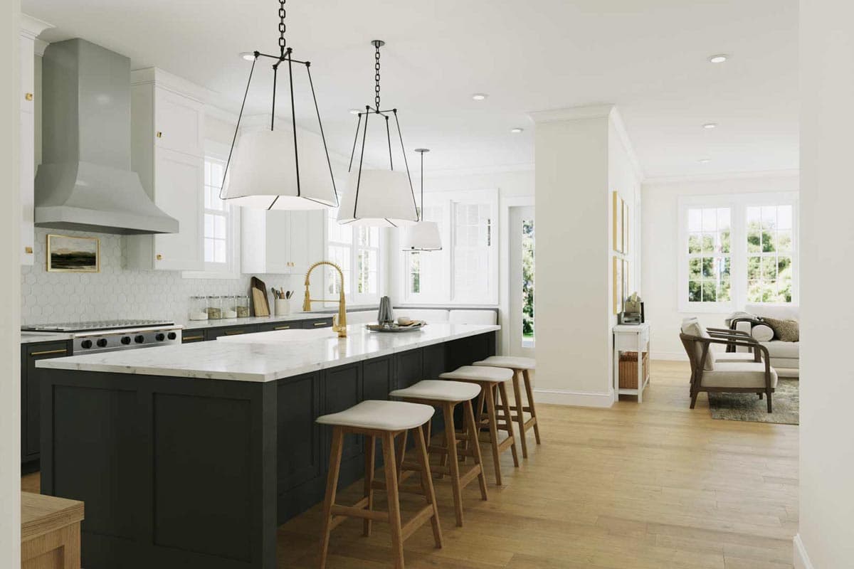 A modern, open-concept kitchen with a large island featuring bar stools, white cabinets, and stylish pendant lighting.