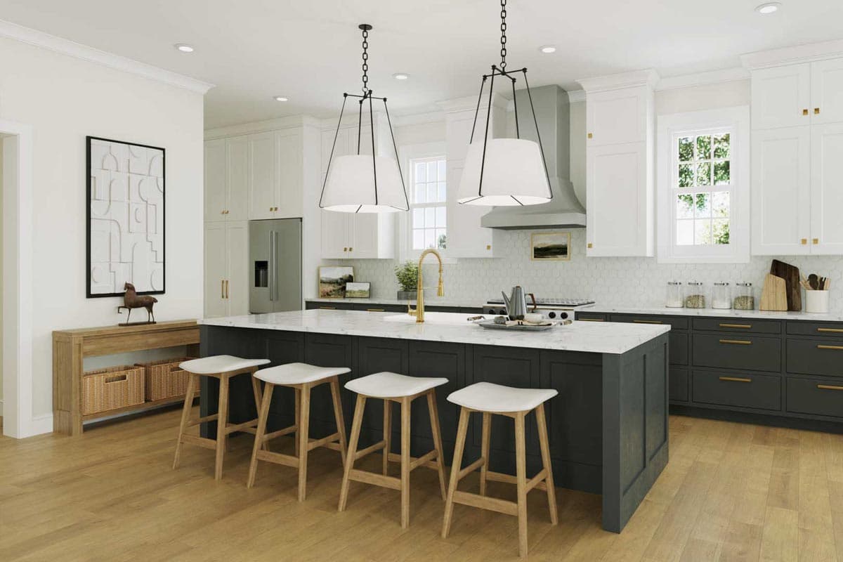 A modern kitchen with a large island, four bar stools, and white and gray cabinets. Two large pendant lights hang above the island.