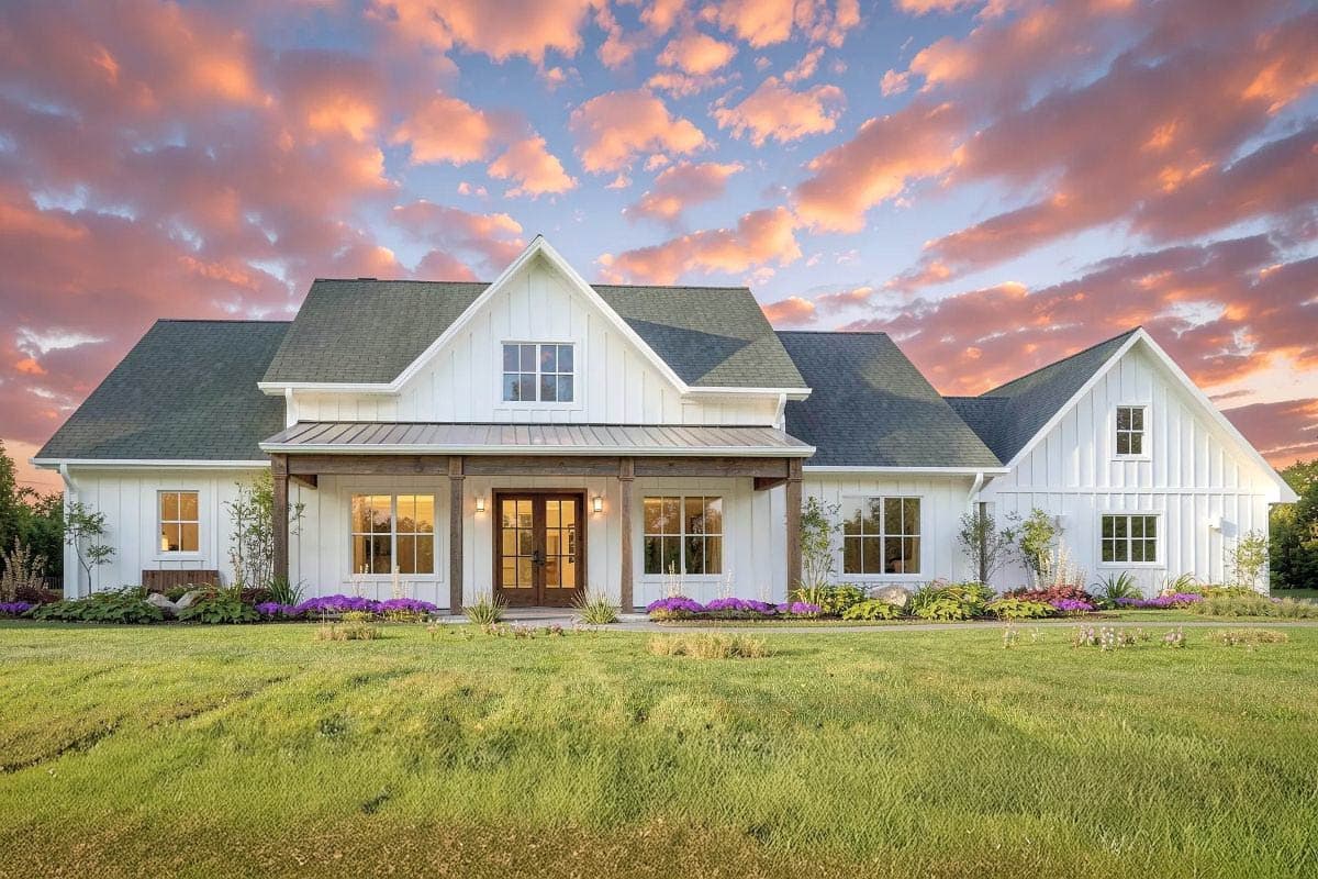 Farmhouse exterior with gabled roof, covered porch, and dormers. Two-story house plan with board and batten siding and a symmetrical facade.