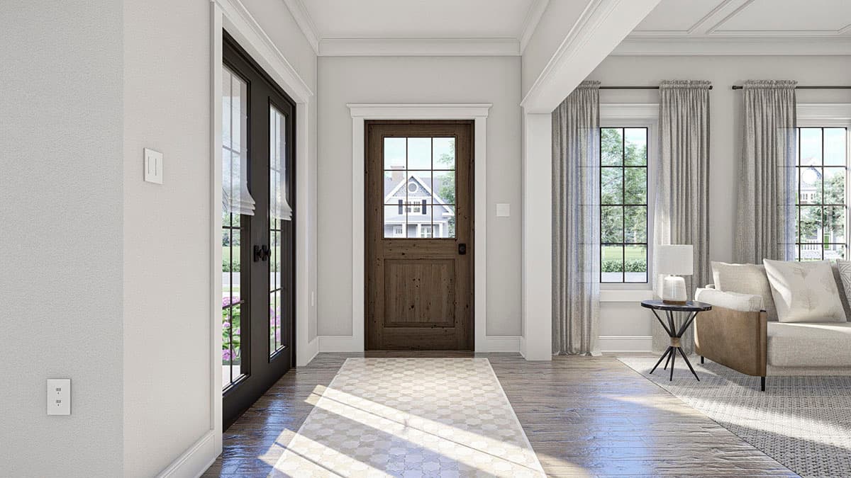 Entryway with rustic wood door, glass sidelights, and tall windows with grid panes. View of house exterior through door.