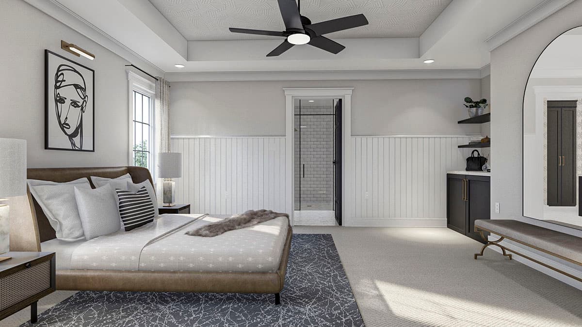Primary bedroom with king bed, vaulted ceiling, ceiling fan, wainscoting, and ensuite shower visible.