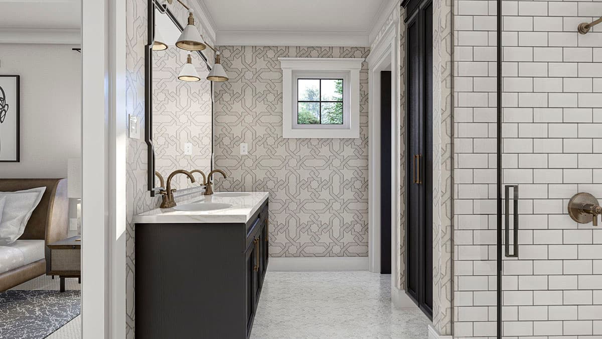 Bathroom featuring double vanity with dark cabinets, geometric wallpaper, and subway tile shower.