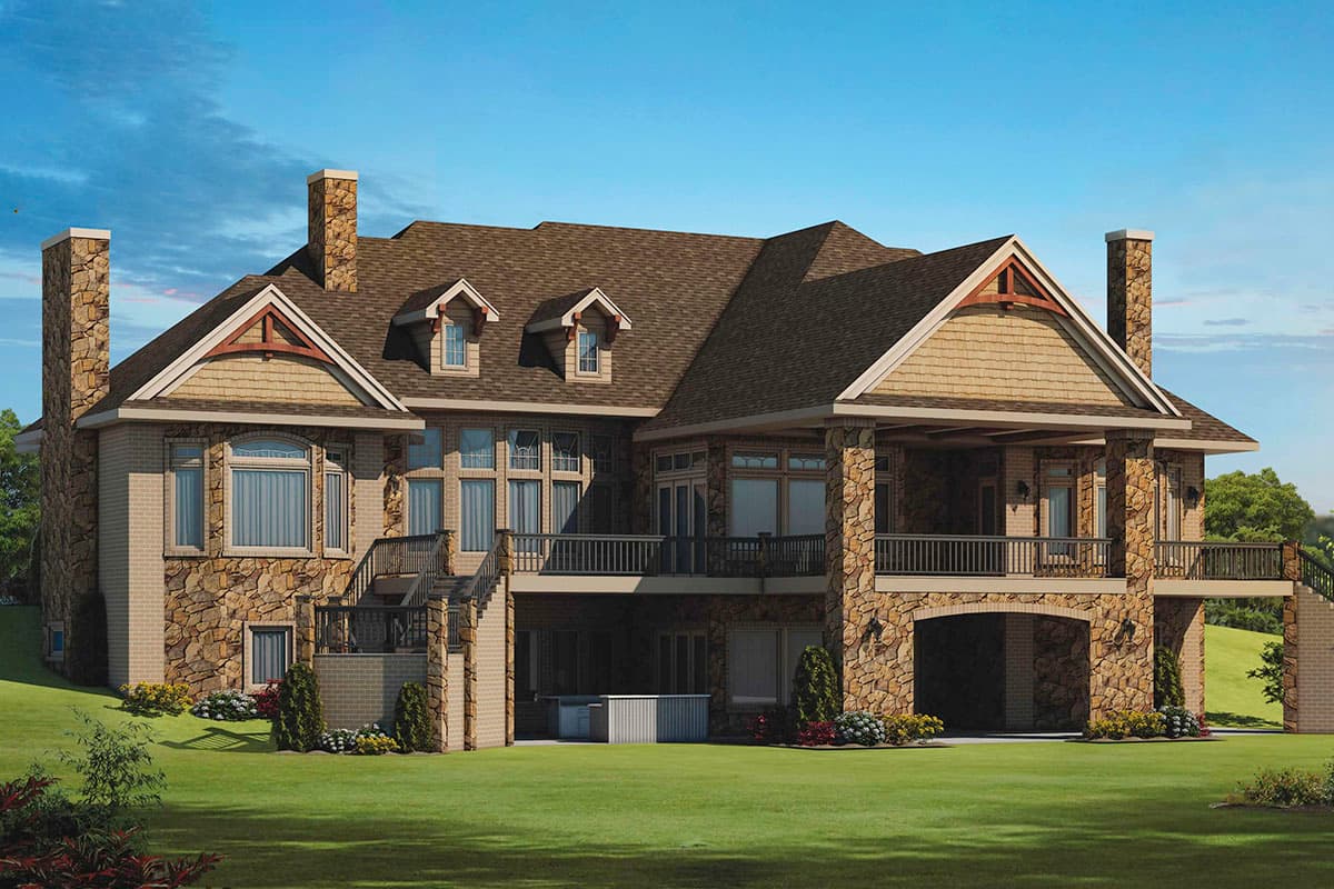 House plan exterior: multi-story home with stone accents, dormers, covered porch with stone columns, and a porte-cochère.