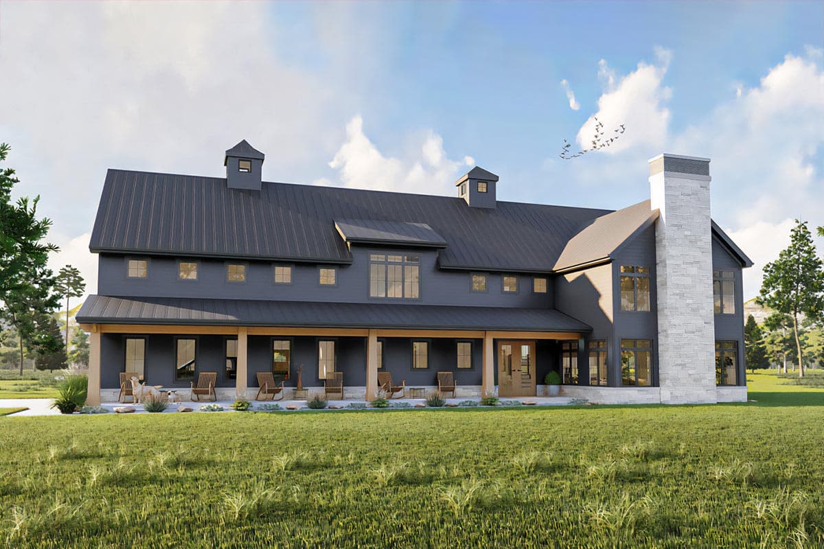 House plan exterior. Two-story Modern Farmhouse with a covered porch, dormers, and a prominent chimney. Dark siding with a metal roof.