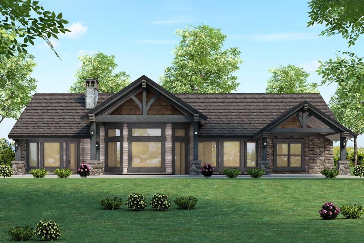 Ranch house plan exterior with stone accents, a prominent gable with timber framing, and a prominent stone chimney.